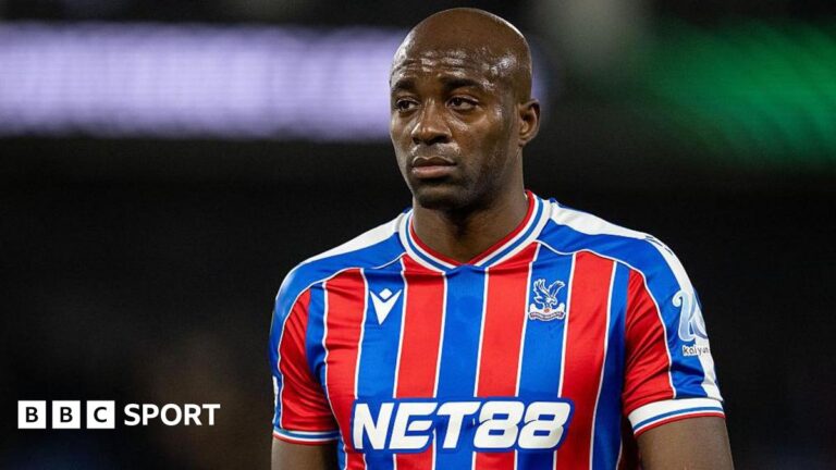 Jean-Philippe Mateta wearing a blue and red striped Crystal Palace shirt