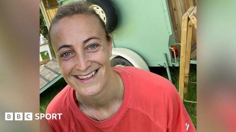 Amy Carr smiling at the camera and wearing a sports shirt