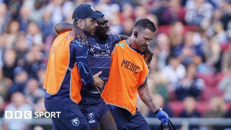 Bristol Bears: How team ‘built back up’ and adapted to injury crisis Gabriel Ibitoye (centre) has his arms around the shoulders of two medical staff (left and right) as he is helped walk off the pitch