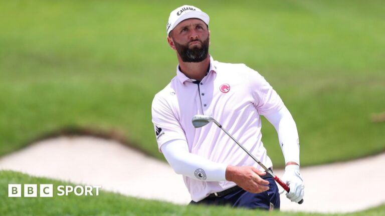 Jon Rahm chips out of a bunker