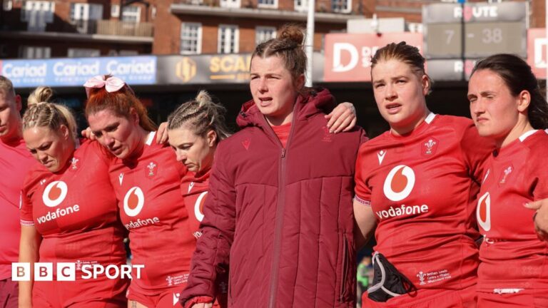Kate Williams of Wales speaks to the players at the end of the match