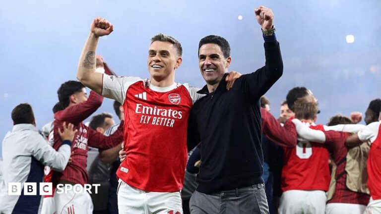 Leandro Trossard and Mikel Arteta celebrating on the Emirates Stadium pitch after beating Atletico Madrid.