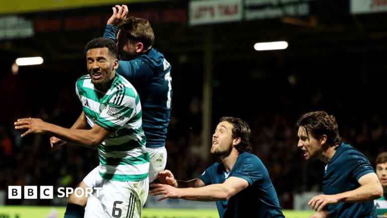 Referee John Beaton is surrounded by Celtic players