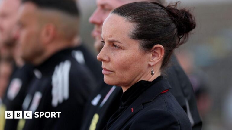 Wales boss Rhian Wilkinson lines up for the anthem