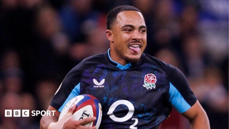 Max Ojomoh playing for England with his arms by his side in an expression of mock bewilderment