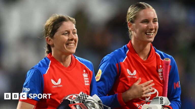 Alice Capsey is hugged by a team-mate