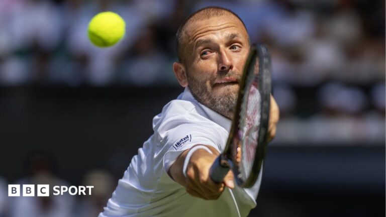 Dan Evans stretches to hit a backhand volley