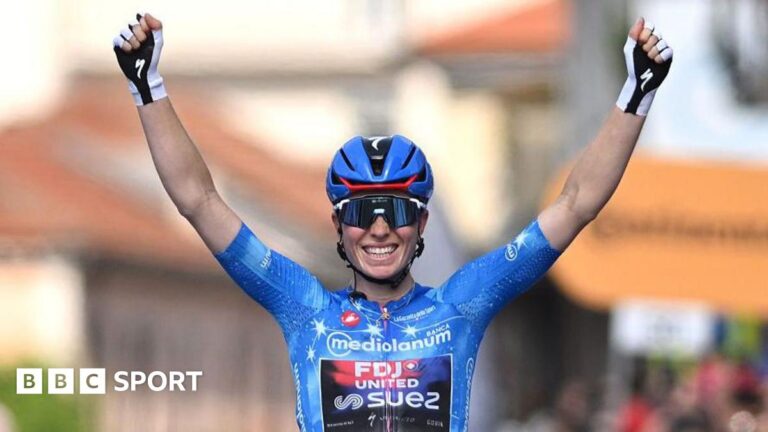 Demi Vollering celebrates at the finish line after clinching the overall victory in the women's Giro d'Italia of 2026