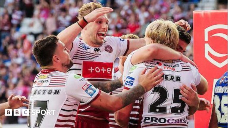 Super League: Wigan Warriors 30-18 Warrington Wolves – young stand-ins impress for hosts Wigan Warriors player Taylor Kerr, number 25 with his back to camera, is embraced and congratulated by team-mates after scoring a try.