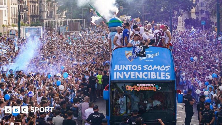 Players on the bus at the Malaga promotion parade