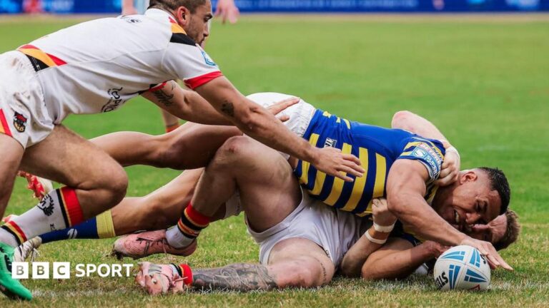 Albert Hopoate touches the ball down under pressure from Bulls defenders