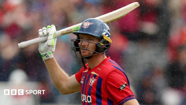 Jos Buttler wearing a helmet and raising his bat while playing for Manchester Super Giants